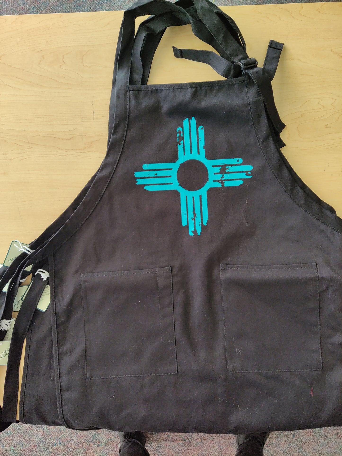 AP-133T Distressed Zia - Turquoise Ink on Black Apron